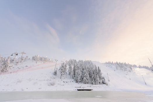 Rukatunturi ski jumping hill in winter season and nice weather and blue sky in winter season and sunset time at Ruka ski Rukatunturi, Finland