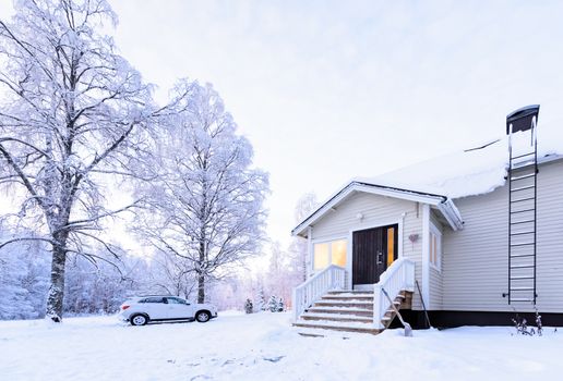 The house in the forest has covered with heavy snow in winter season at Lapland, Finland.