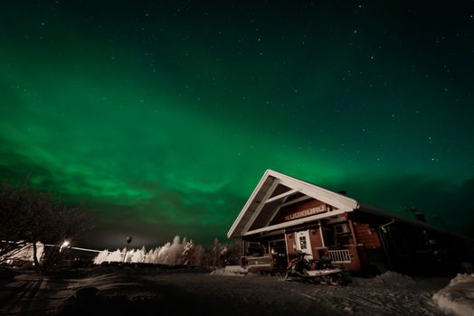 The northern lights Aurora Borealis at Kuukiuru village lake in Lapland, Finland.