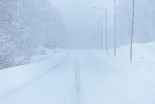 The road number 496  has covered with heavy snow and bad weather in winter season at Tuupovaara, Finland.