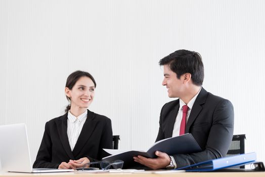 A manager and secretary working together in the office.