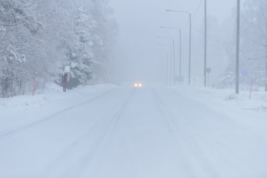 The road number 496  has covered with heavy snow and bad weather in winter season at Tuupovaara, Finland.