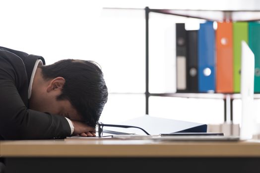 A businessman slept in the working time at the office.