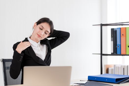 A businesswoman has taken a rest and stretching on the office chair with smiling and happiness.