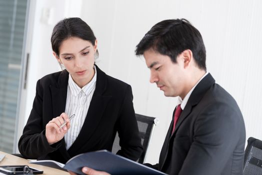 A manager and secretary working together in the office.