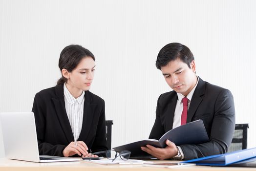 A manager and secretary working together in the office.