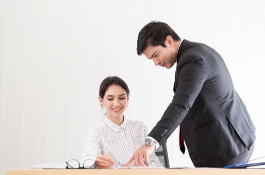 A manager and secretary working together in the office.