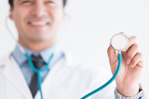 A senior doctor isolated has holding the stethoscope on white background.