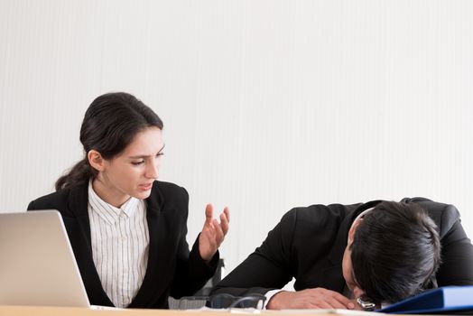 A businesswoman has upset with to sleep of the workmate in the working time at the office.