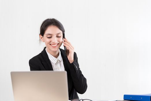 A businesswoman has talking about the job with concentrate and happiness.