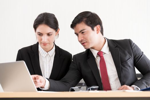 A manager and secretary working together in the office.