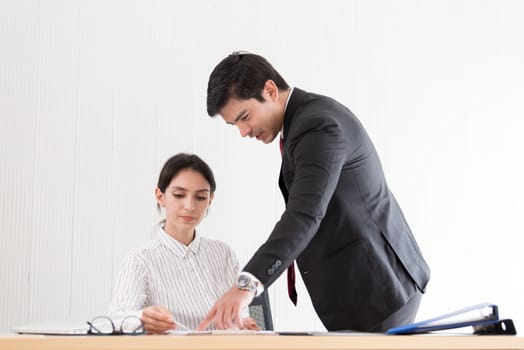 A manager and secretary working together in the office.