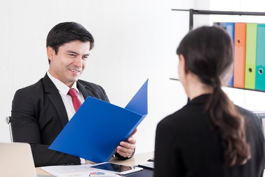 A businessman listens and talking to candidate woman answers for a job interview.