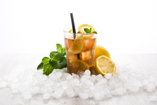 Iced tea drink with lemon in glass isolated on white background