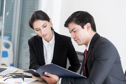 A manager and secretary working together in the office.