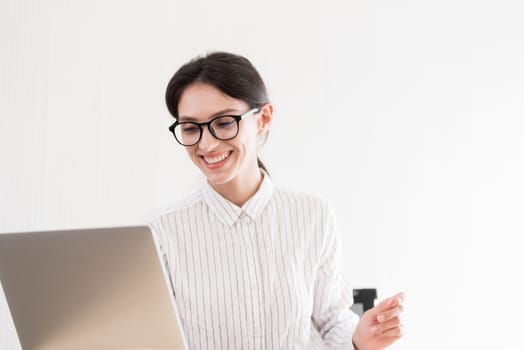 A businesswoman wearing glasses working with smiling and happiness at the office.