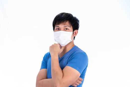 Asian young man in blue t-shirt top and medical mask to protect COVID-19 with isolated on white background concept.