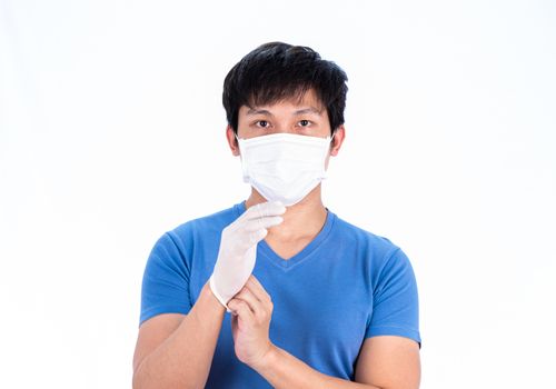 Asian young man in blue t-shirt top with medical mask and latex gloves to protect COVID-19 with isolated on white background concept.