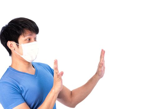 Asian young man in blue t-shirt top and medical mask to protect COVID-19 with isolated on white background concept.