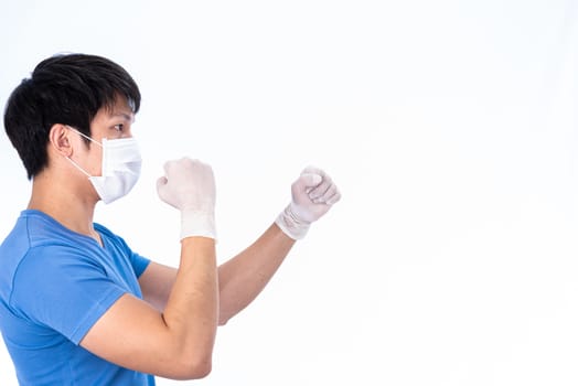 Asian young man in blue t-shirt top with medical mask and latex gloves to protect COVID-19 with isolated on white background concept.