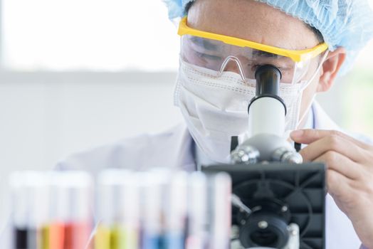 Asian young man student scientist researching  and learning in a laboratory.