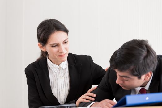 A businesswoman has upset with to sleep of the workmate in the working time at the office.