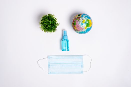 The face of equipment to protect COVID-19, eyeglasses, blue mask, and hand cleaner gel to save the world Isolated on white background concept.