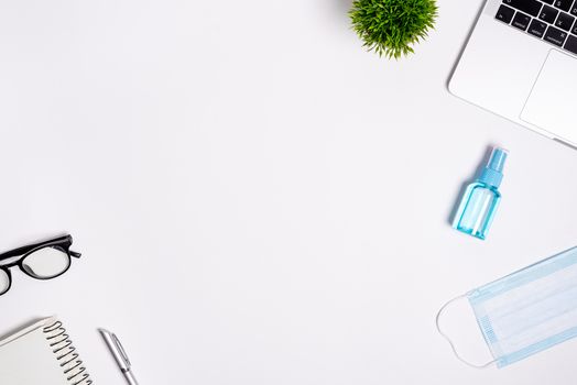 The equipment to protect COVID-19, blue mask and hand cleaner gel for preparing to work from home Isolated on white background concept.