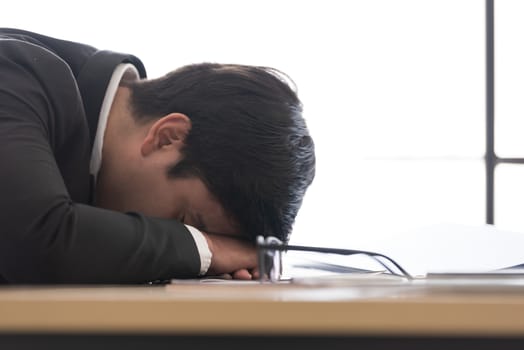 A businessman slept in the working time at the office.