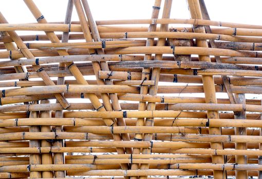 A traditional handmade bamboo fence made from slats and strips