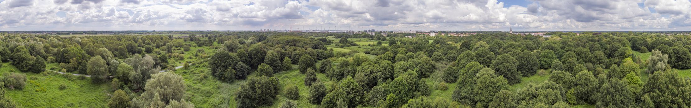 360 aerial panorama over Oude Landen nature park in Ekeren, with village and harbor in the distance. Travel and tourism