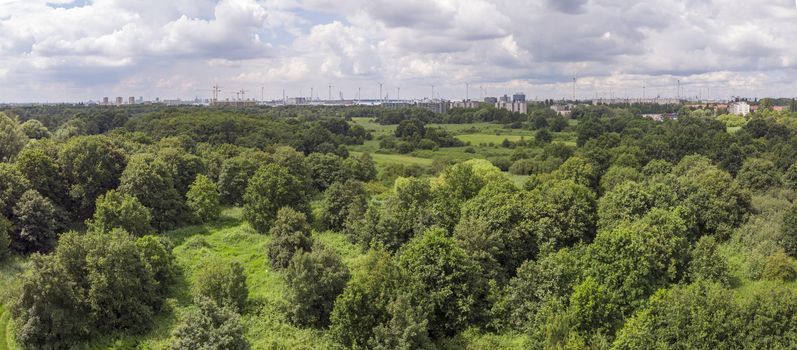 aerial panorama over Oude Landen nature park in Ekeren, with village and harbor in the distance. Travel and tourism