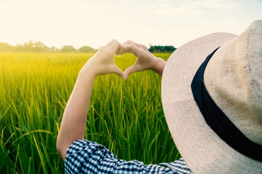 The hand of a farmer girl is made in the shape of a heart to show her love of her career and nature.