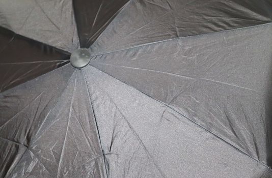 Close up view at the colorful surface of a rainproof umbrella