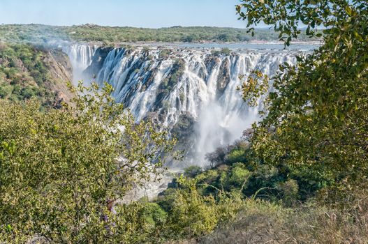 The Ruacana waterfall in the Kunene River. Angola is visible behind the falls