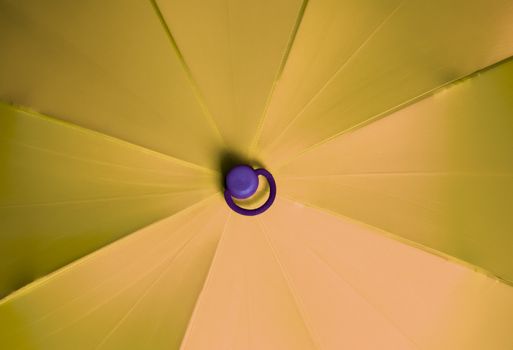 Close up view at the colorful surface of a rainproof umbrella