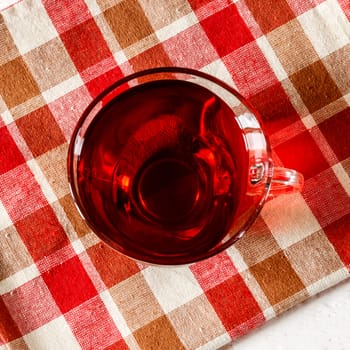 Cup of Karkadeh Red Tea on a white wooden table