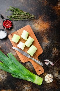Chopped leek for cooking Braised Leeks with herbs ingredients , on rustic metall background dark, top view