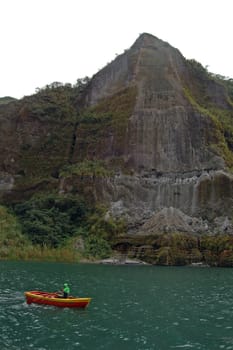 ZAMBALES, PH-OCT 5: Crater lake Pinatubo with boat on October 5, 2015 in Zambales, Philippines. Lake Pinatubo is the summit crater lake of Mt. Pinatubo formed after its eruption on June 1991.