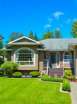 Main entrance and nice lawn in front of suburban family house