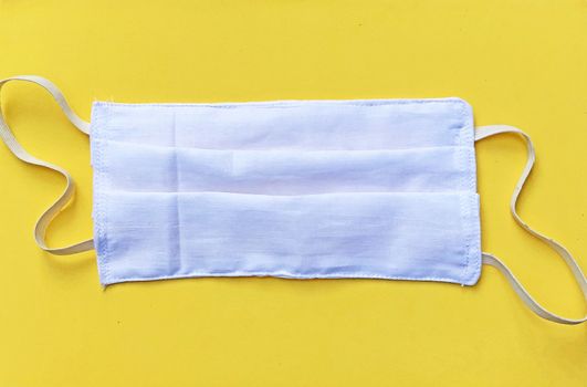 Face mask isolated in the yellow background