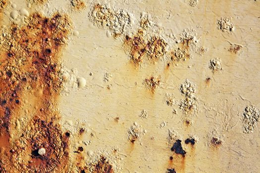 Rust covered weathered iron metal texture background with yellow peeling blistering paint