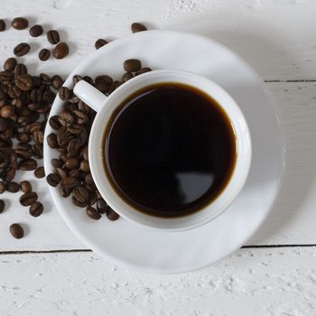 Coffee cup and saucer on a white wooden table