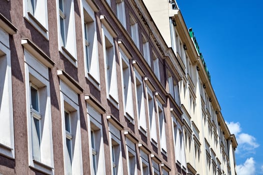 Fragment of the facade of a building with a number of windows in the city of Poznan