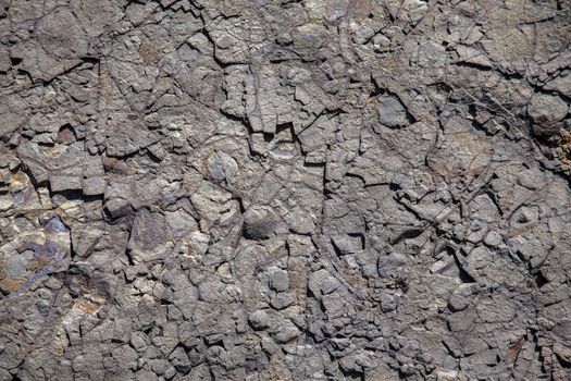 Volcanic weathered stone rock close up texture background 