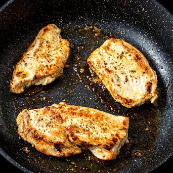 Turkey steak grilled in a pan. The cooking process.