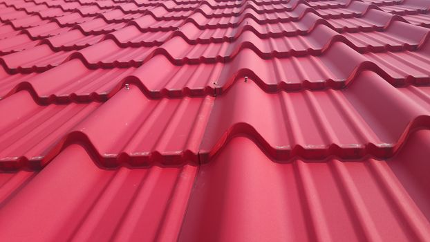 Closeup of red color roof tiles. Background texture for rooftop tiles.