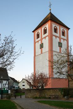 Center of village Odenthal with parish church and old buildings at sunrise, Bergisches Land, Germany