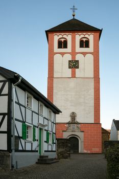 Center of village Odenthal with parish church and old buildings at sunrise, Bergisches Land, Germany