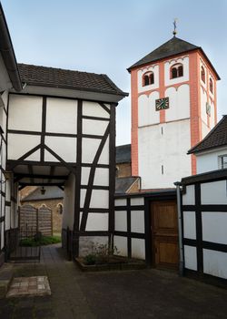 Center of village Odenthal with parish church and old buildings at sunrise, Bergisches Land, Germany